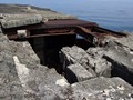 Destroyed steel and concrete roof above Battery McRae. In the foreground is the access route to the upper deck of Fort Drum.